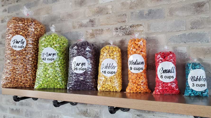Popcorn sizes.  'Nibbler' size is about 3 cups. 'Small' size is about 6 cups.  'Medium' size is about 9 cups.  'Gobbler' size is about 16 cups. 'Large' size is about 26 cups.  'X-Large' size is about 42 cups.  'Party' size is about 110 cups.